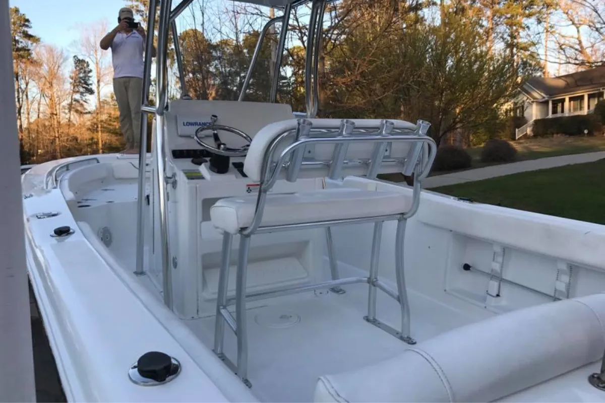 Clean white center console boat interior with steering wheel and seating