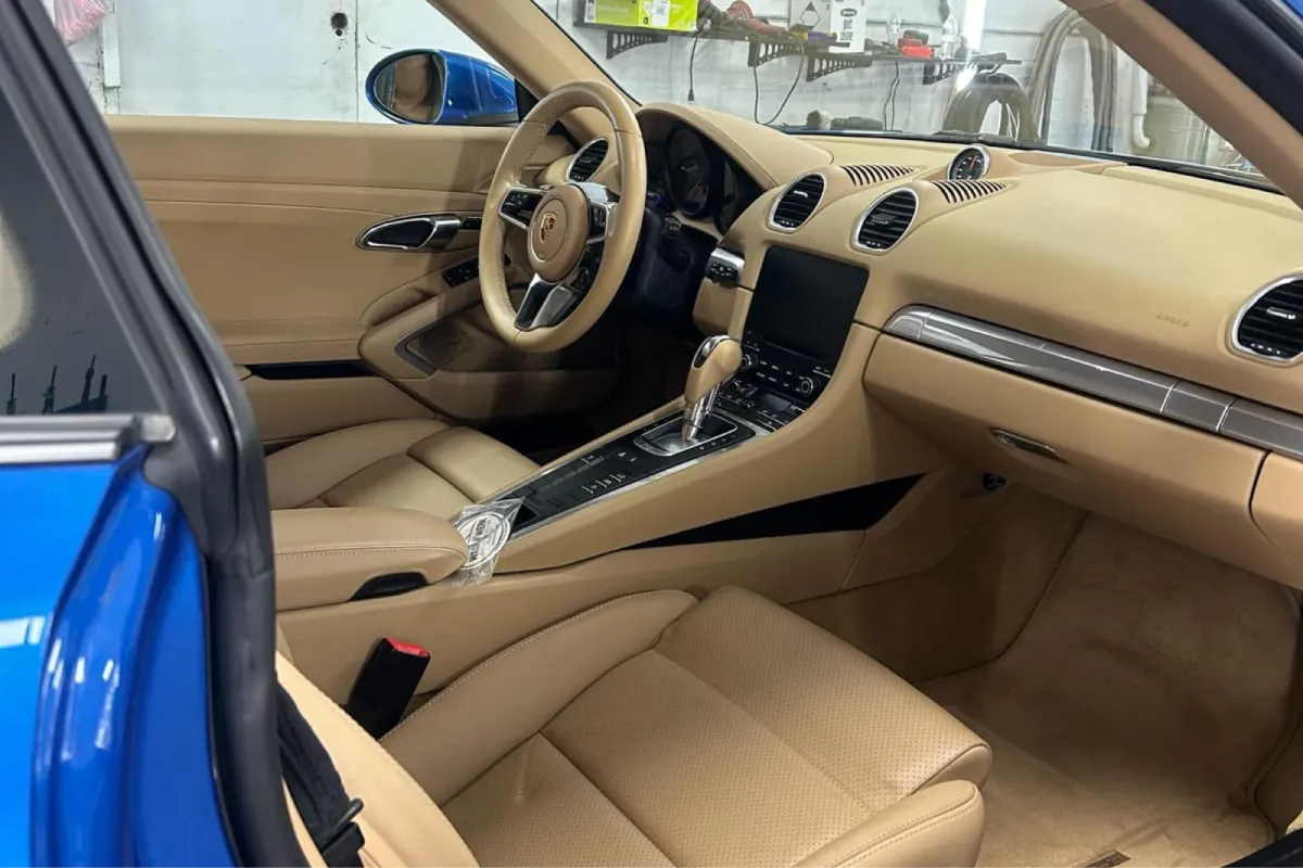 Detailed Porsche interior with clean tan leather seats.