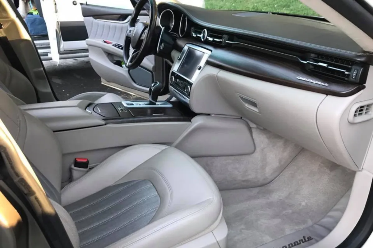 Detailed Maserati interior with clean leather seats and carpets.