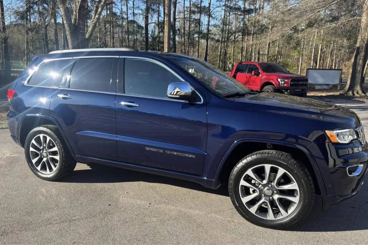 Blue Jeep parked outdoors in natural light