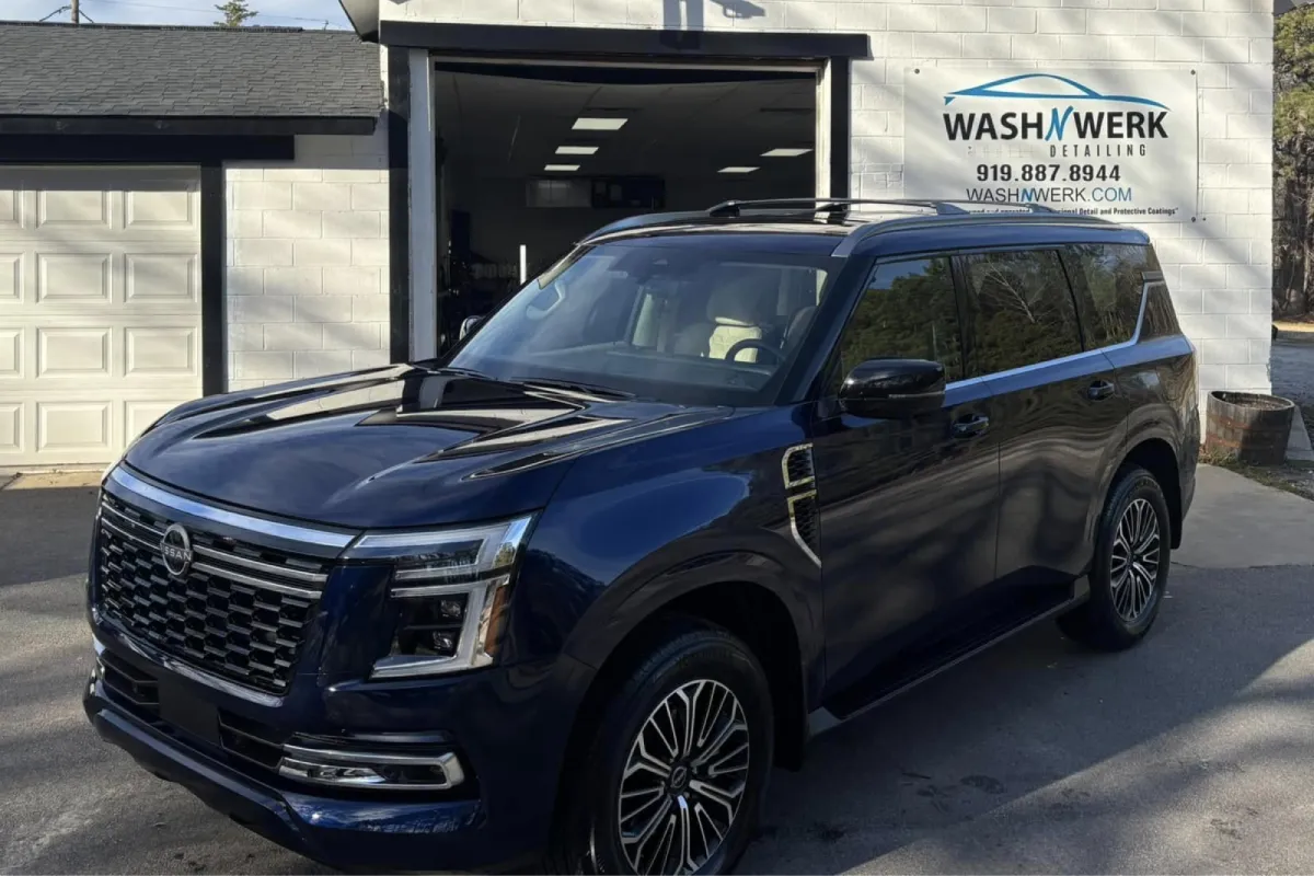Blue SUV parked outside a detailing shop