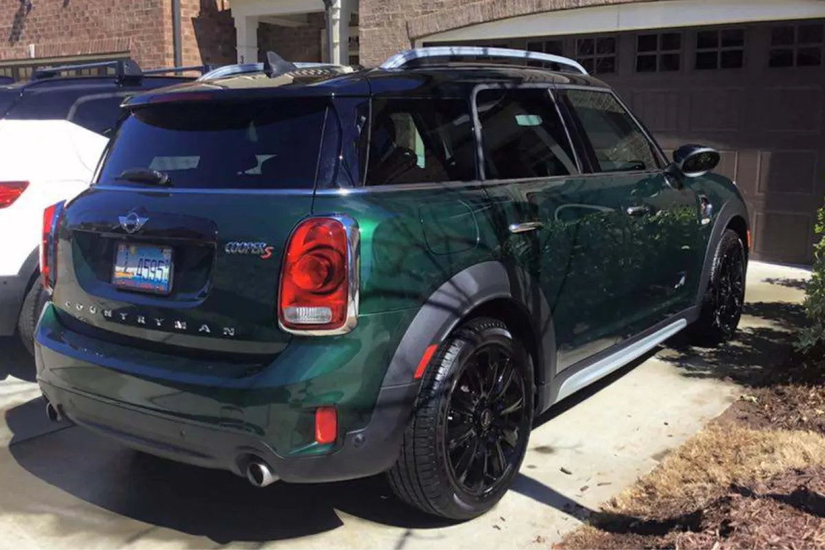 A side view of the green Mini Countryman SUV, showcasing its clean appearance.