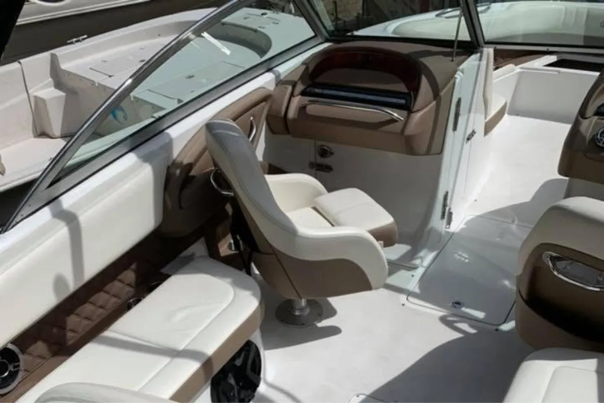 Clean boat interior with detailed white and tan seating.