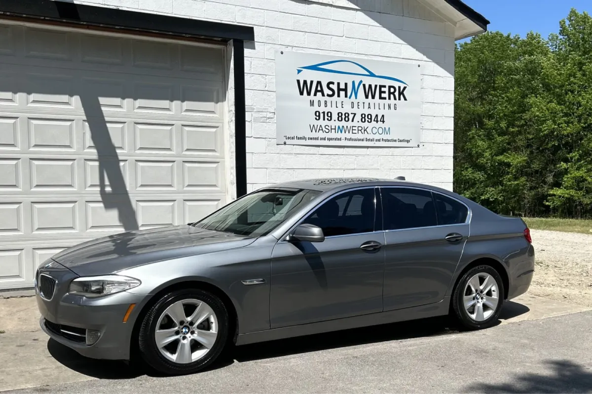 Gray BMW sedan with dark window tint.