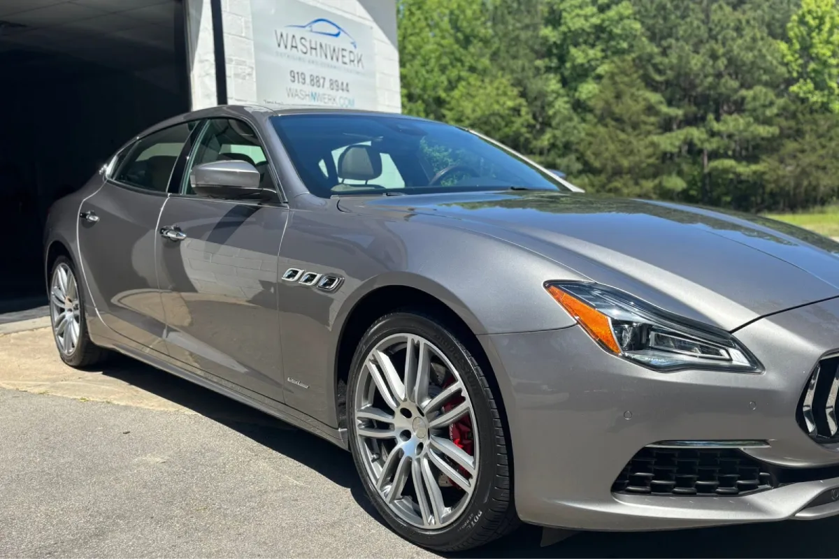 Silver Maserati with a polished exterior after paint correction.